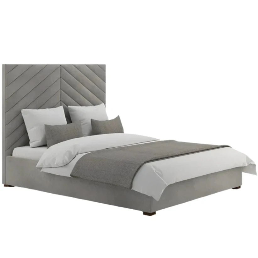 Annika bed with a grey chevron-patterned headboard and upholstered frame, styled with white sheets and grey pillows.